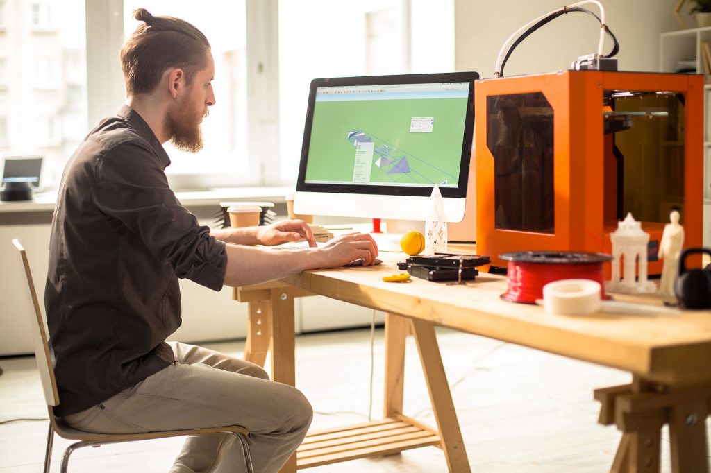 man working with 3D printer